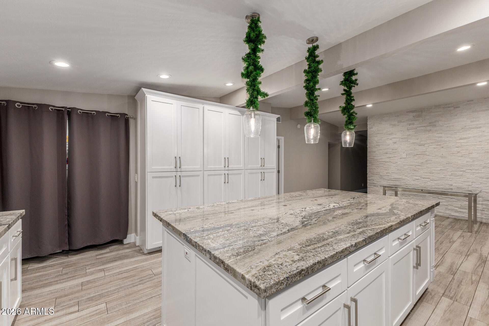 15041 North 6th Street Phoenix, AZ 85022 - Photo 17 of 45 an empty room with kitchen view and wooden floor