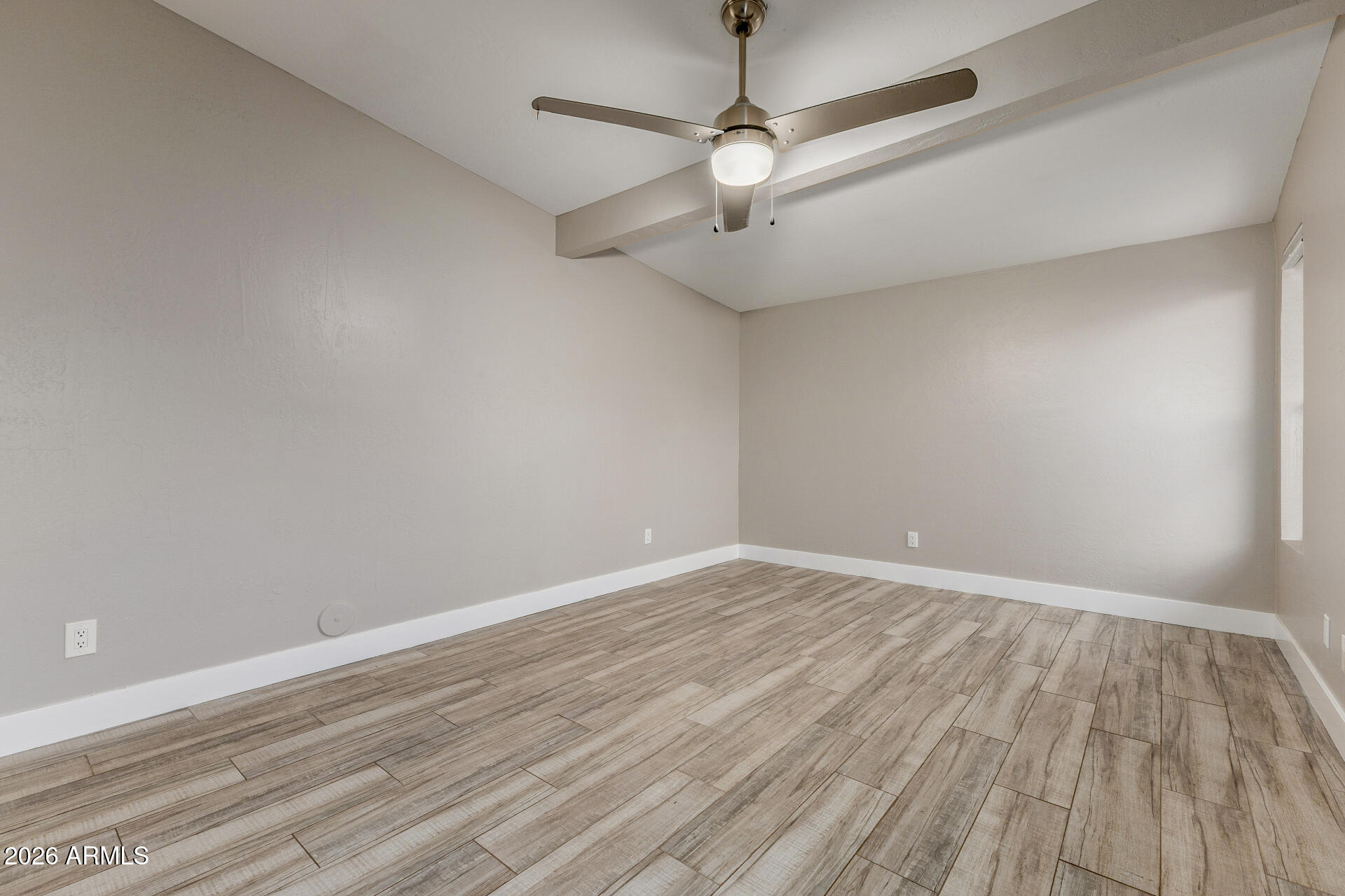 15041 North 6th Street Phoenix, AZ 85022 - Photo 21 of 45 an empty room with wooden floor ceiling fan and window