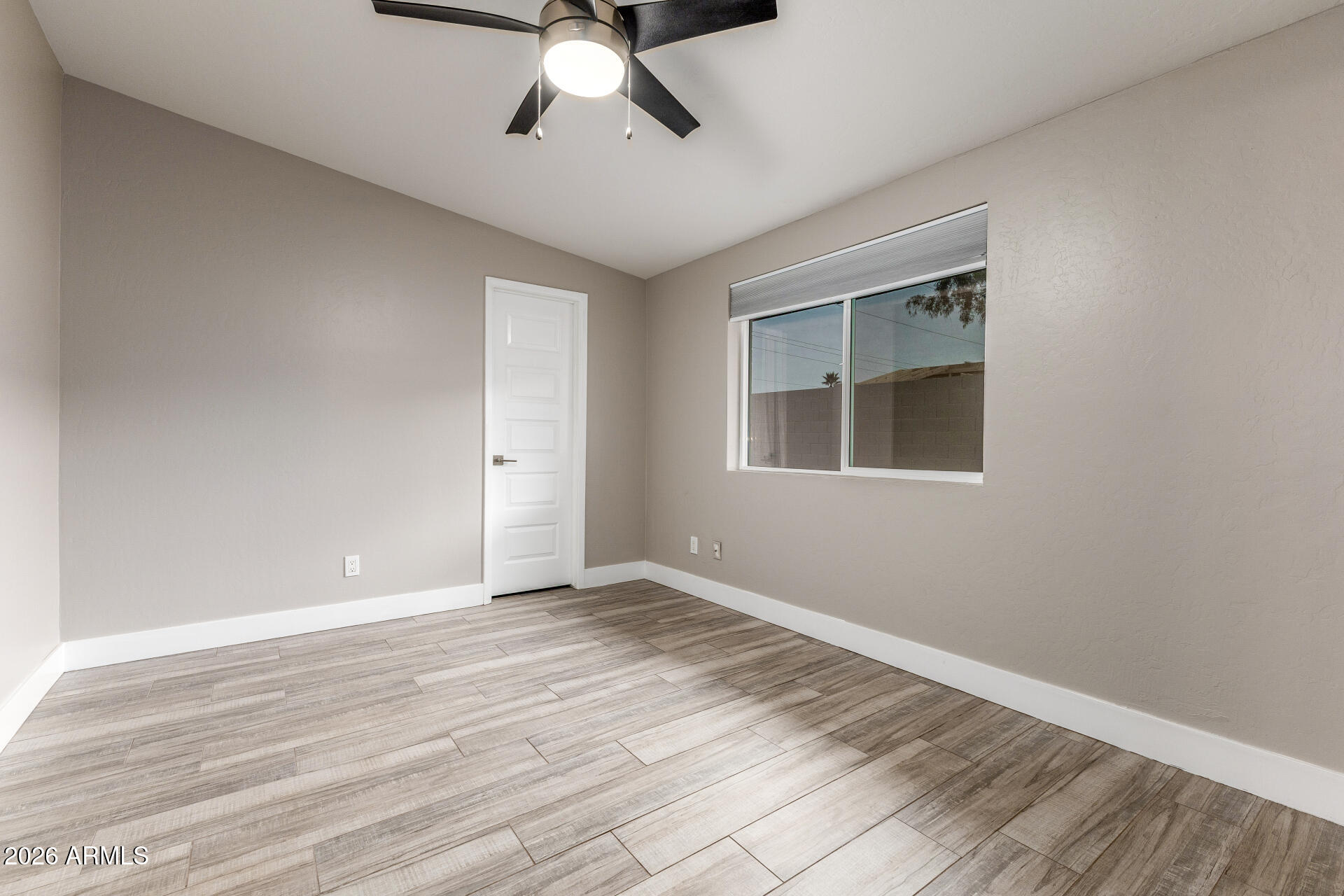15041 North 6th Street Phoenix, AZ 85022 - Photo 25 of 45 a view of an empty room with wooden floor and a window