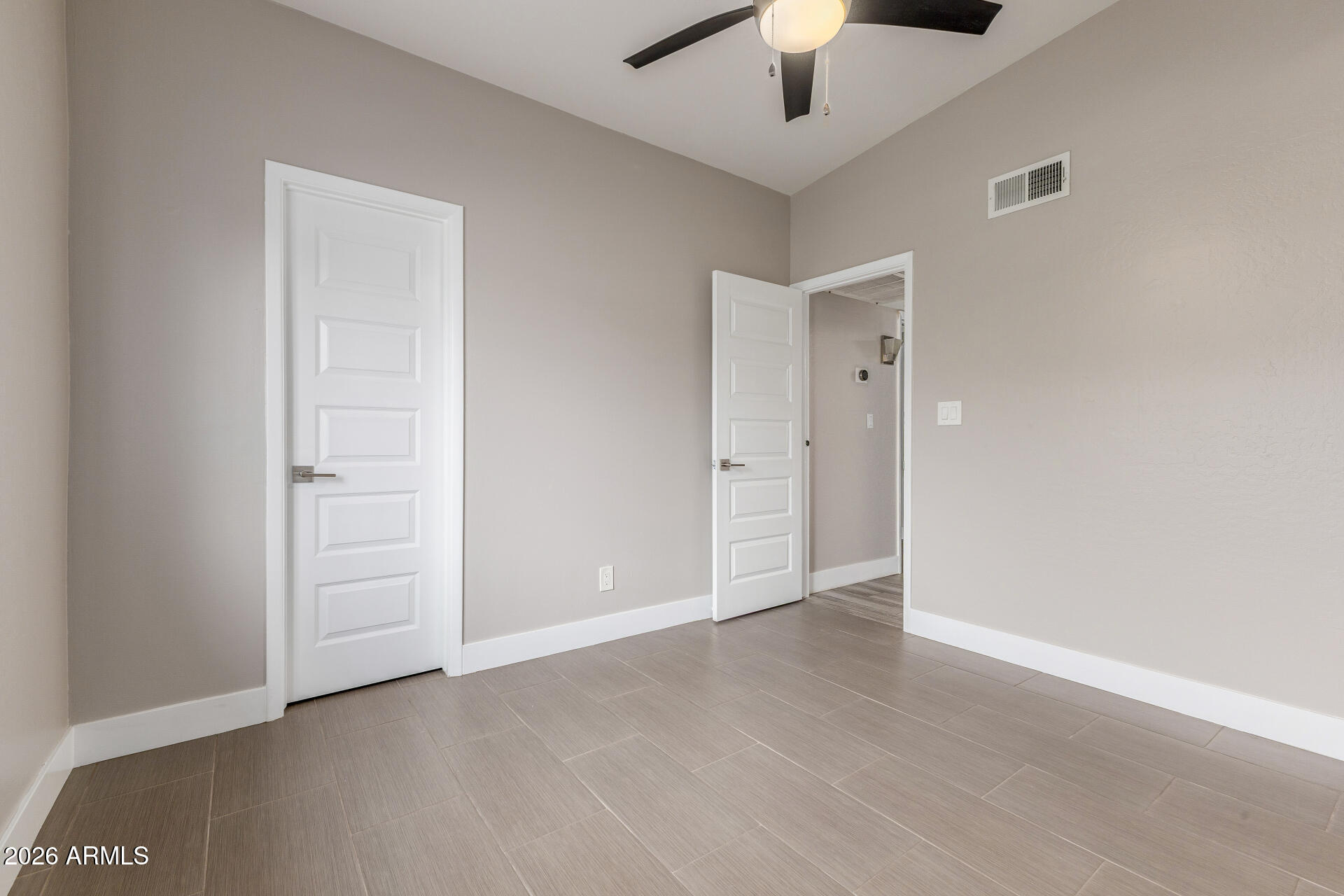 15041 North 6th Street Phoenix, AZ 85022 - Photo 28 of 45 an empty room with closet and a chandelier fan