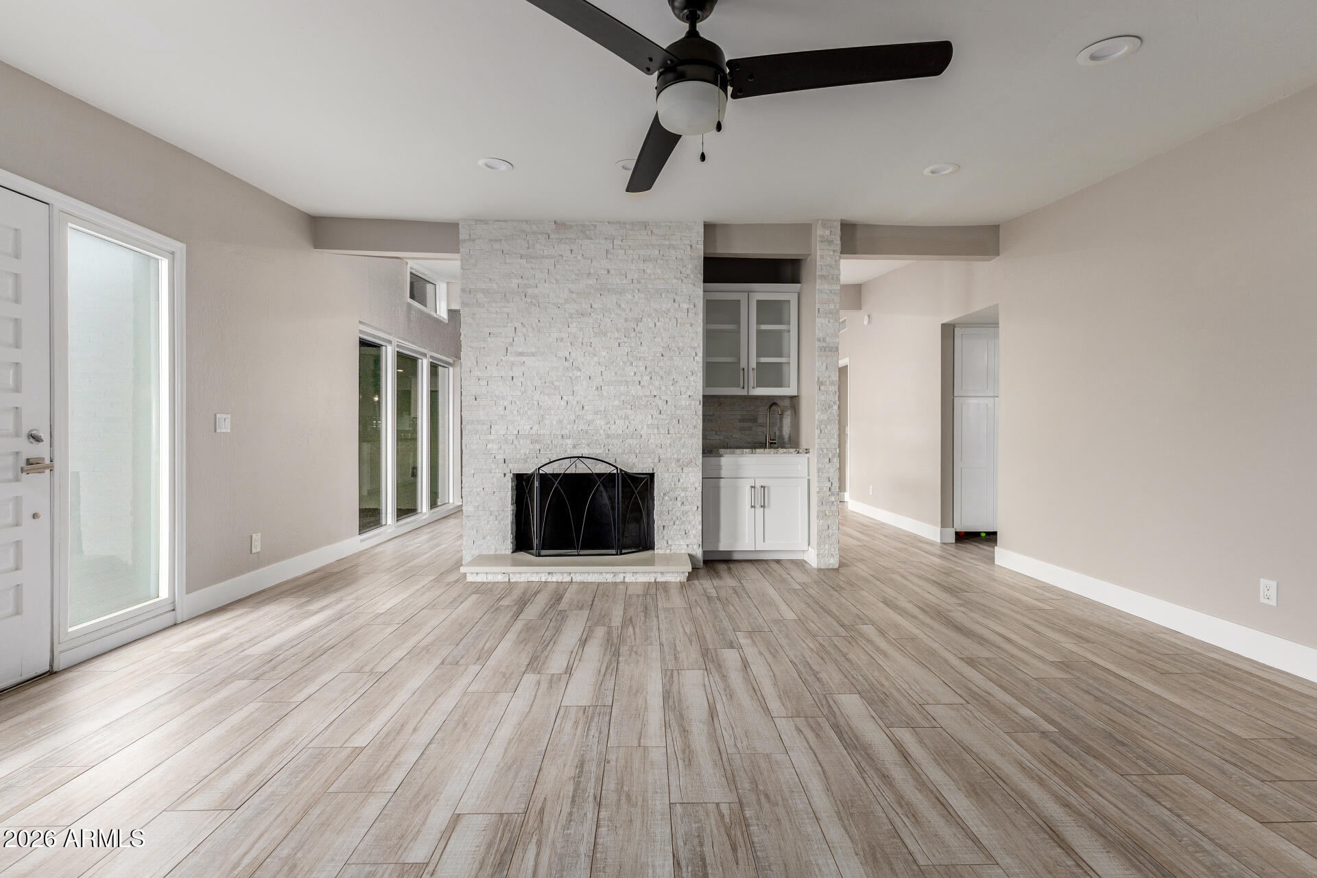 15041 North 6th Street Phoenix, AZ 85022 - Photo 7 of 45 a view of empty room with wooden floor and fireplace