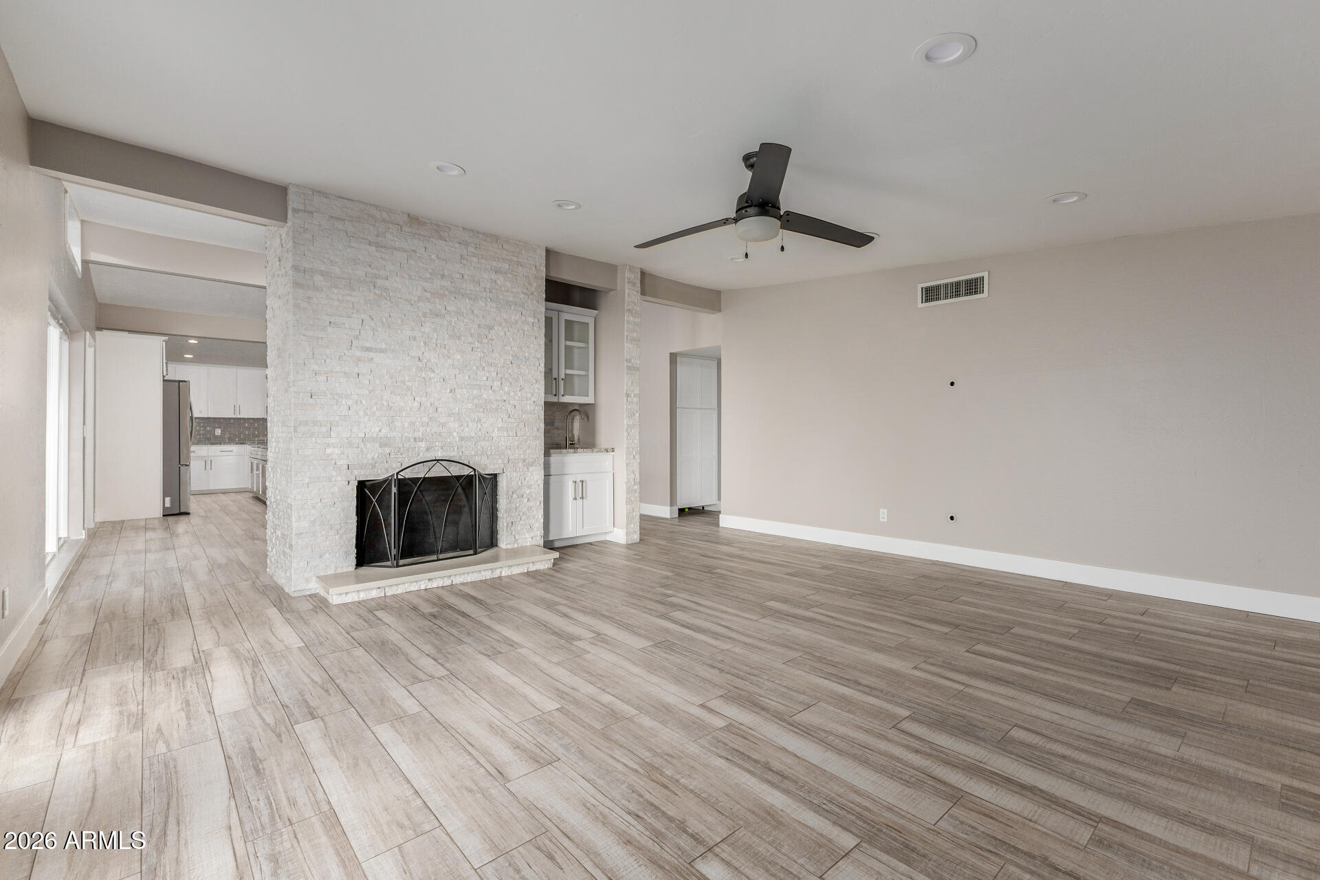 15041 North 6th Street Phoenix, AZ 85022 - Photo 8 of 45 a view of a livingroom with wooden floor and a fireplace