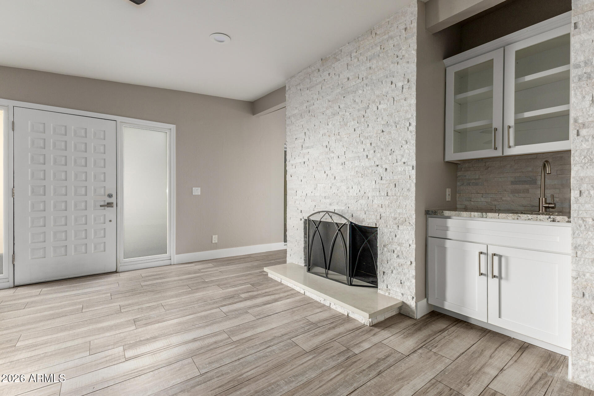 15041 North 6th Street Phoenix, AZ 85022 - Photo 9 of 45 a view of a livingroom with wooden floor and a fireplace