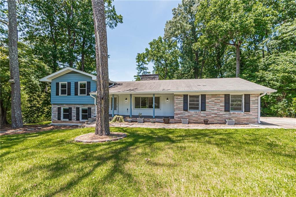 1574 Old Spring House Lane Atlanta, GA 30338 - Photo 1 of 55 a front view of a house with a garden