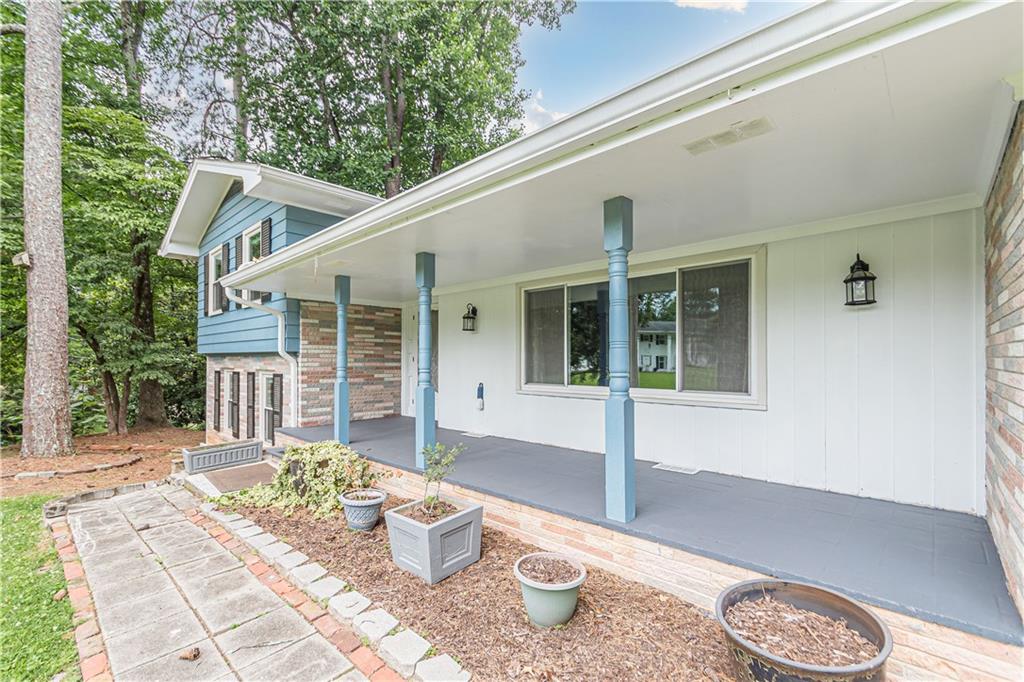 1574 Old Spring House Lane Atlanta, GA 30338 - Photo 11 of 55 a front view of a house with a yard