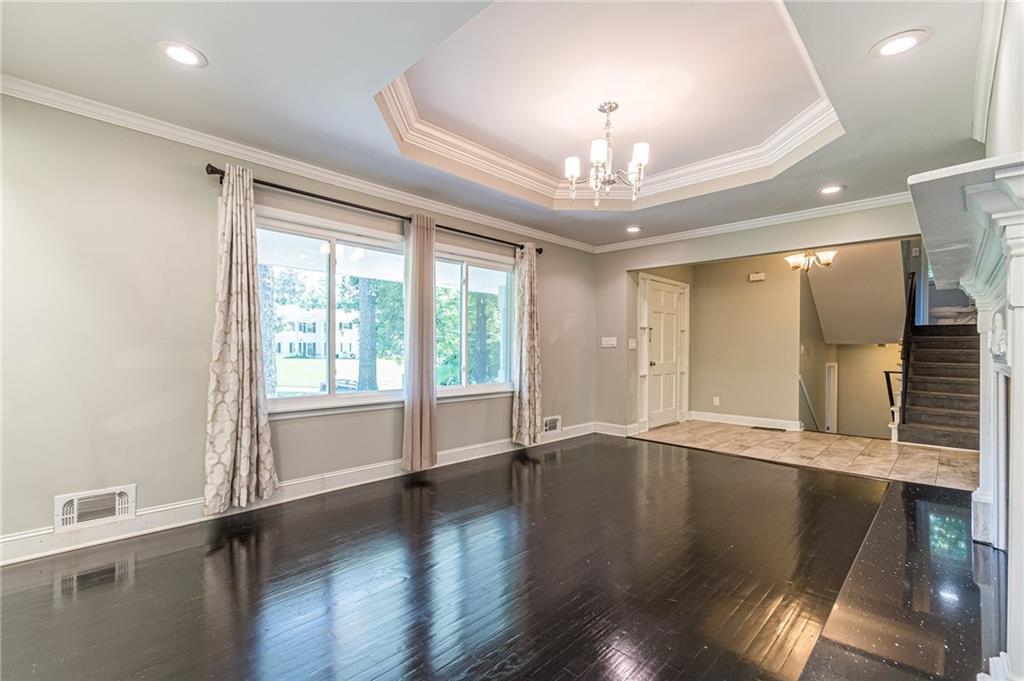 1574 Old Spring House Lane Atlanta, GA 30338 - Photo 12 of 55 a view of an empty room with wooden floor and a window