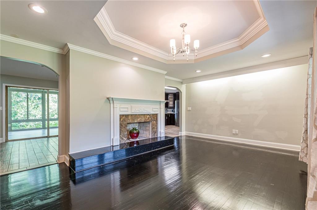 1574 Old Spring House Lane Atlanta, GA 30338 - Photo 15 of 55 a view of a livingroom with a fireplace a chandelier and wooden floor