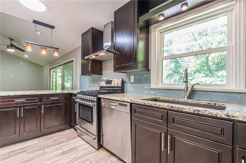1574 Old Spring House Lane Atlanta, GA 30338 - Photo 17 of 55 a kitchen with granite countertop stainless steel appliances and sink