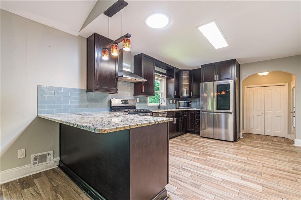 1574 Old Spring House Lane Atlanta, GA 30338 - Photo 19 of 55 a kitchen with stainless steel appliances granite countertop a sink a stove and a refrigerator