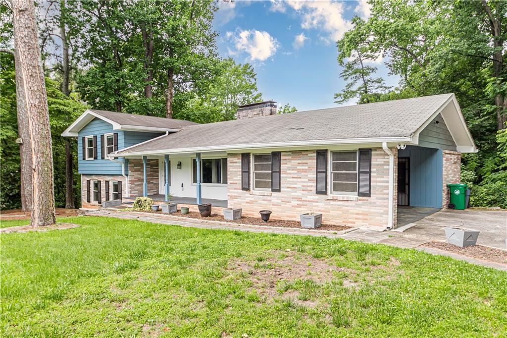 1574 Old Spring House Lane Atlanta, GA 30338 - Photo 2 of 55 a front view of a house with a garden and patio