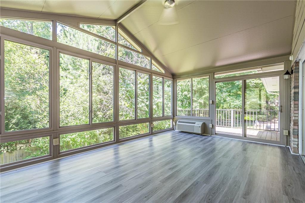 1574 Old Spring House Lane Atlanta, GA 30338 - Photo 27 of 55 a view of empty room with wooden floor and floor to ceiling windows
