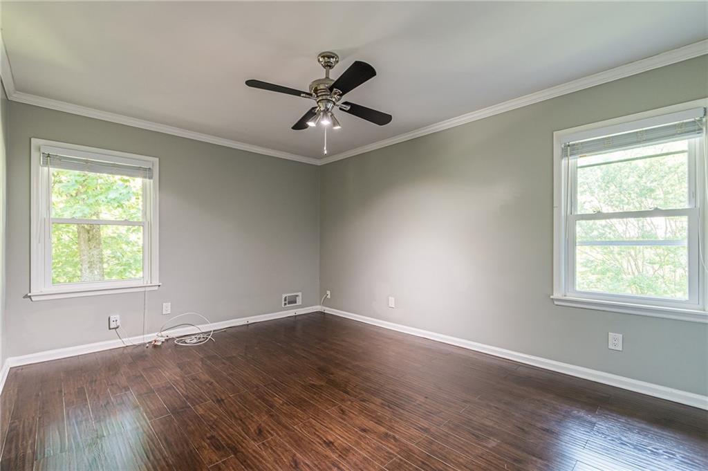 1574 Old Spring House Lane Atlanta, GA 30338 - Photo 30 of 55 a view of an empty room with wooden floor and a window