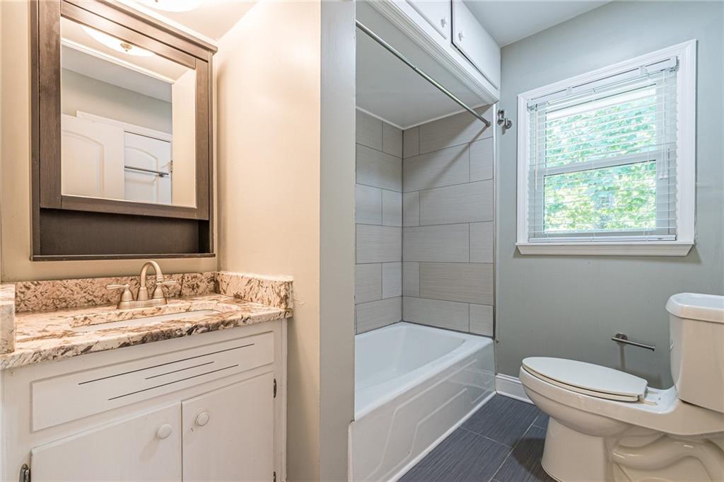 1574 Old Spring House Lane Atlanta, GA 30338 - Photo 33 of 55 a bathroom with a granite countertop sink a toilet and shower