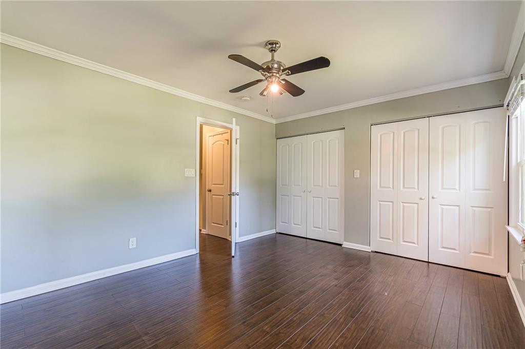 1574 Old Spring House Lane Atlanta, GA 30338 - Photo 36 of 55 an empty room with wooden floor a ceiling fan and windows