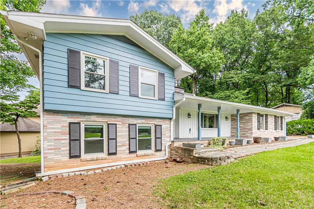 1574 Old Spring House Lane Atlanta, GA 30338 - Photo 4 of 55 a front view of a house with a yard table and chairs