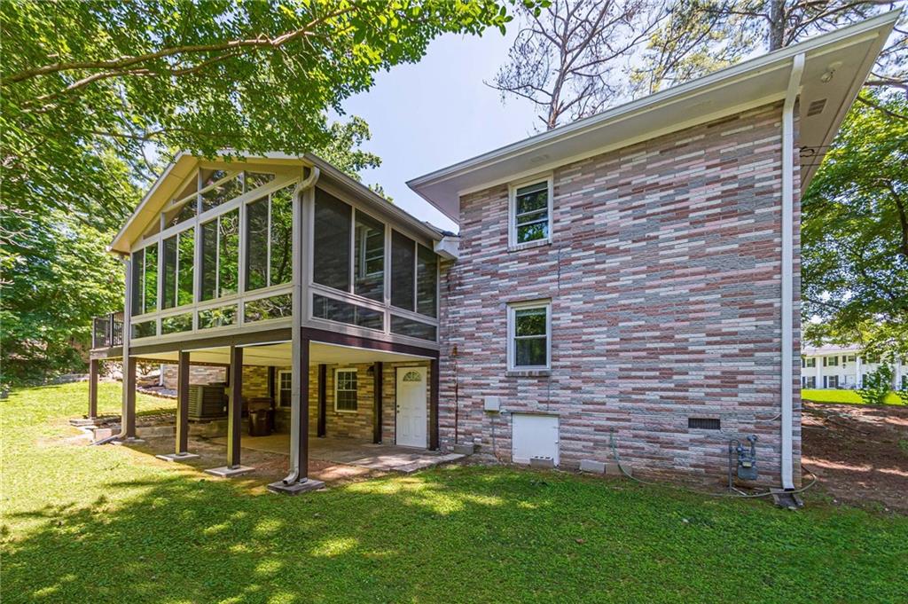 1574 Old Spring House Lane Atlanta, GA 30338 - Photo 50 of 55 a view of a wooden house with a yard