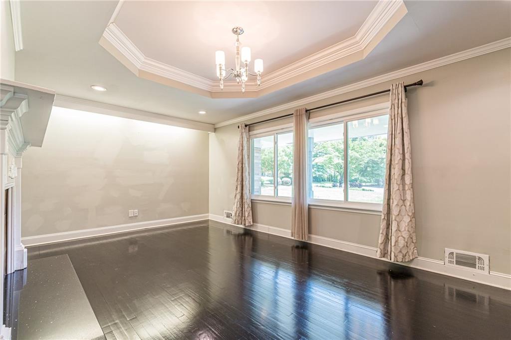 1574 Old Spring House Lane Atlanta, GA 30338 - Photo 10 of 55 a view of an empty room with wooden floor and a window