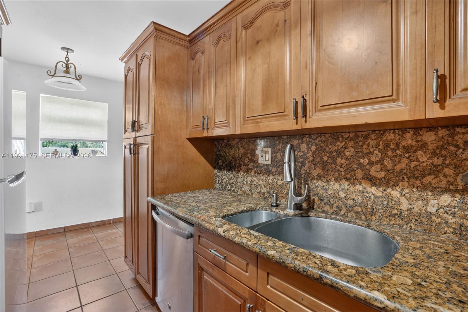 10055 Southwest 52nd Terrace Miami, FL 33165 - Photo 13 of 36 a kitchen with granite countertop a sink and granite top