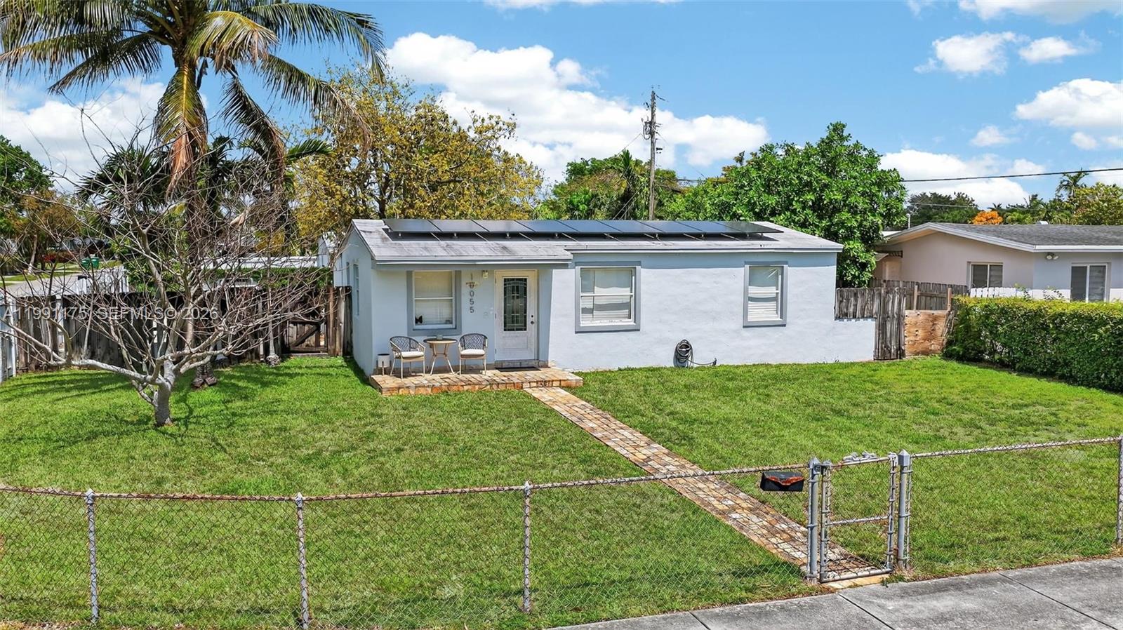 10055 Southwest 52nd Terrace Miami, FL 33165 - Photo 2 of 36 a front view of house with yard and outdoor seating