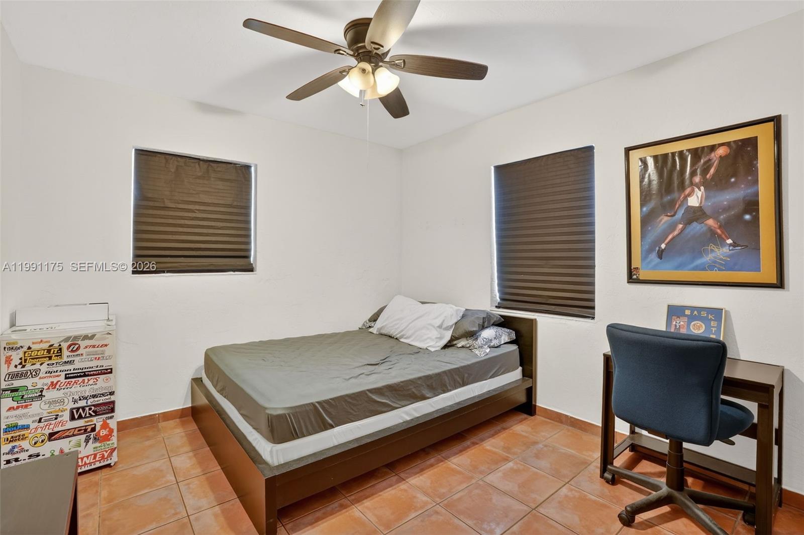10055 Southwest 52nd Terrace Miami, FL 33165 - Photo 22 of 36 a bedroom with a bed a desk and chair