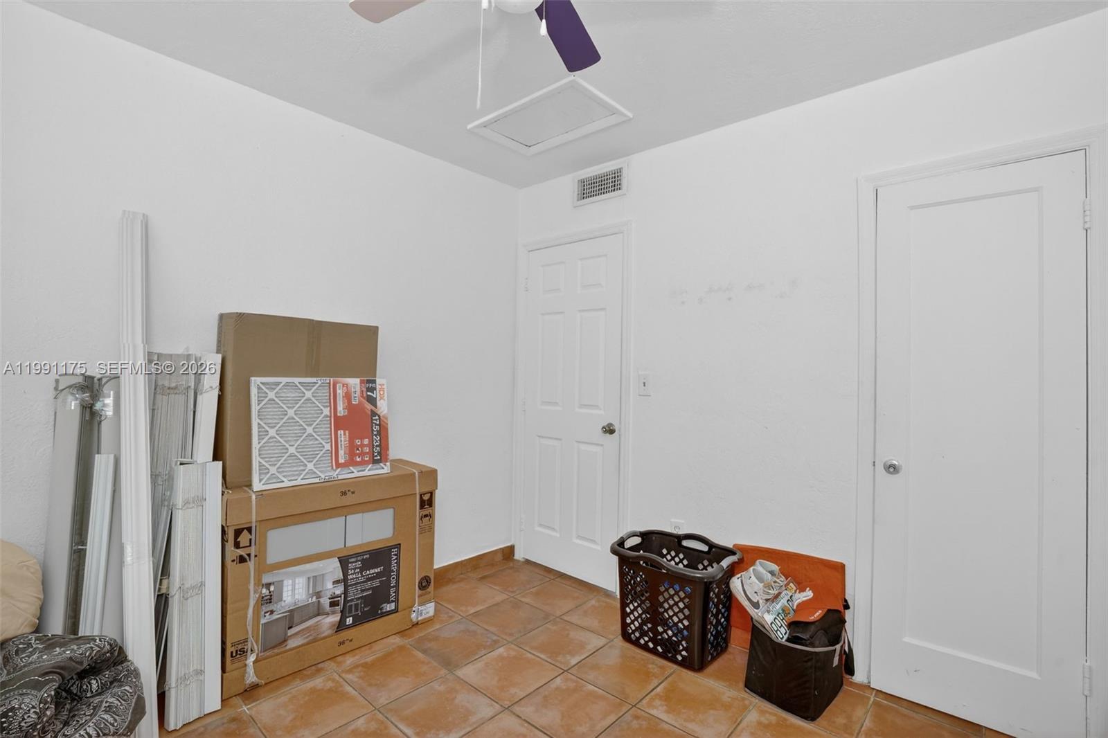 10055 Southwest 52nd Terrace Miami, FL 33165 - Photo 26 of 36 a bedroom with a bed and a chandelier