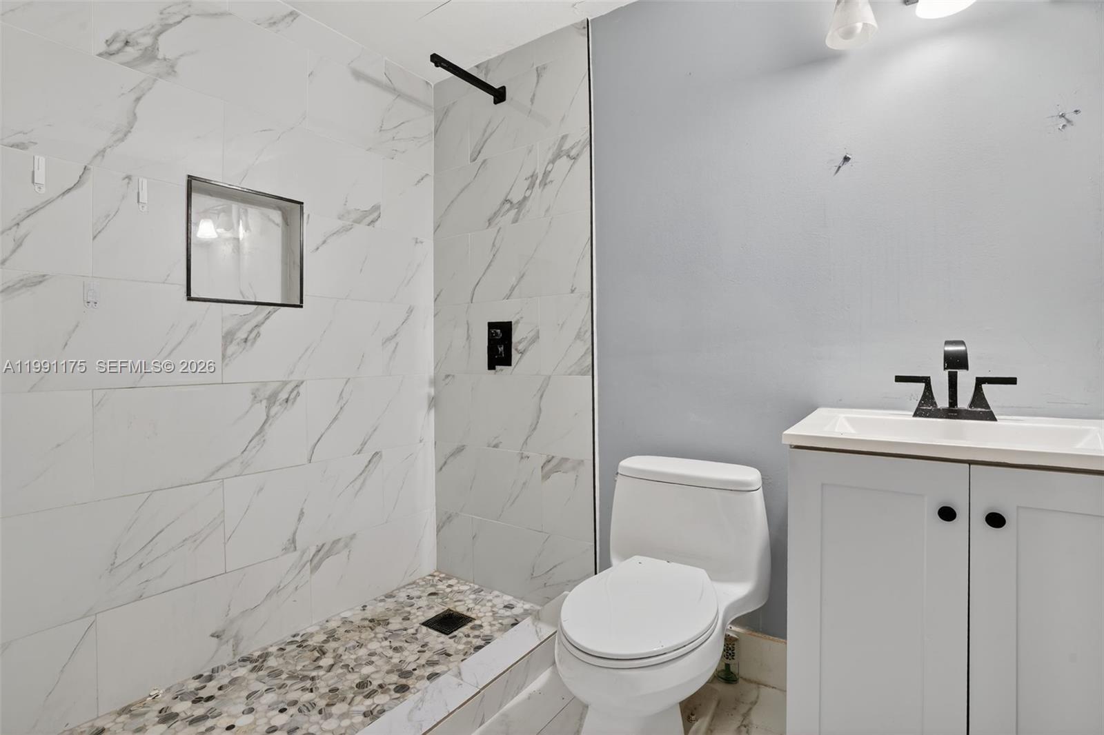 10055 Southwest 52nd Terrace Miami, FL 33165 - Photo 29 of 36 a bathroom with a sink toilet and shower