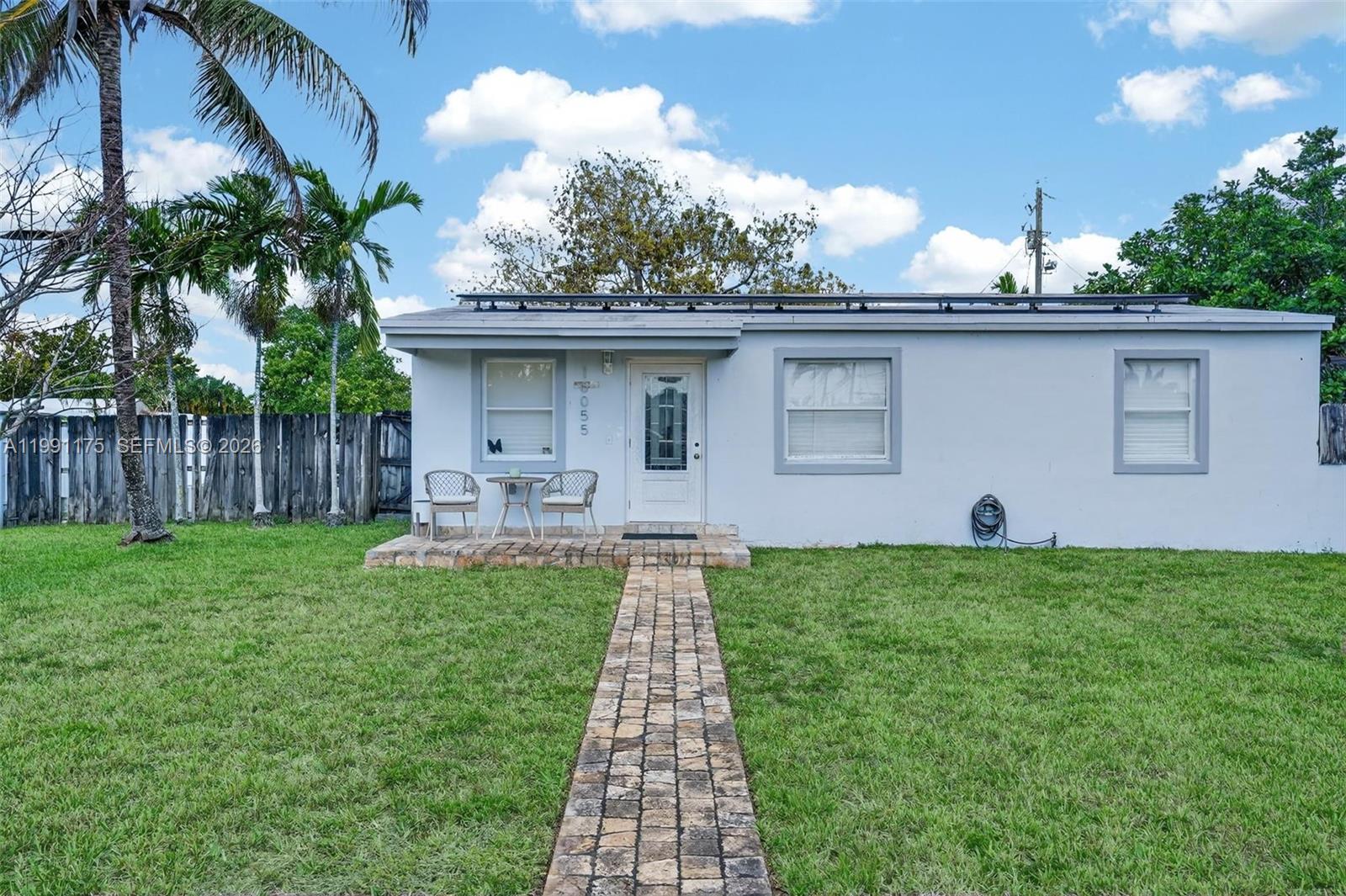 10055 Southwest 52nd Terrace Miami, FL 33165 - Photo 4 of 36 a front view of a house with garden