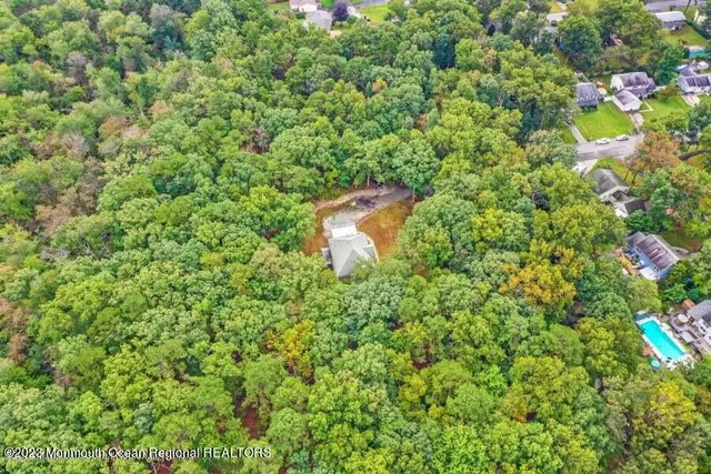 an aerial view of a house with a yard and sitting area