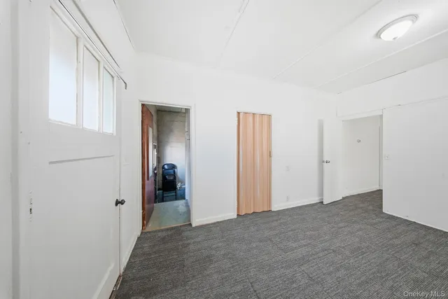 a view of a livingroom with wooden floor and closet