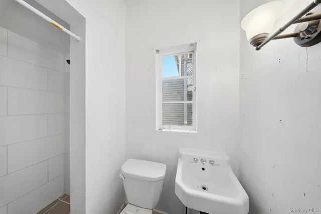 a white toilet sitting next to a bathroom sink