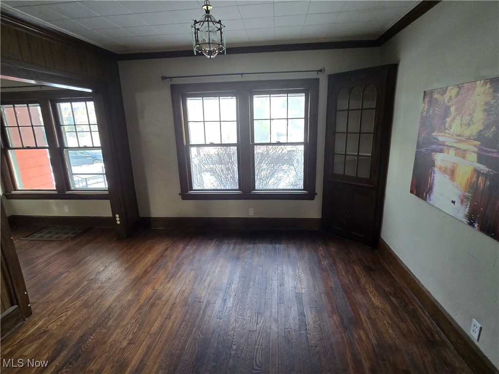2048 Rossmoor Road Cleveland Heights, OH 44118 - Photo 13 of 29 Unfurnished dining area featuring crown molding and dark wood-style flooring