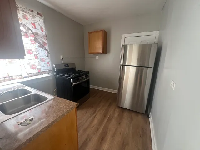 a kitchen with a refrigerator and a sink