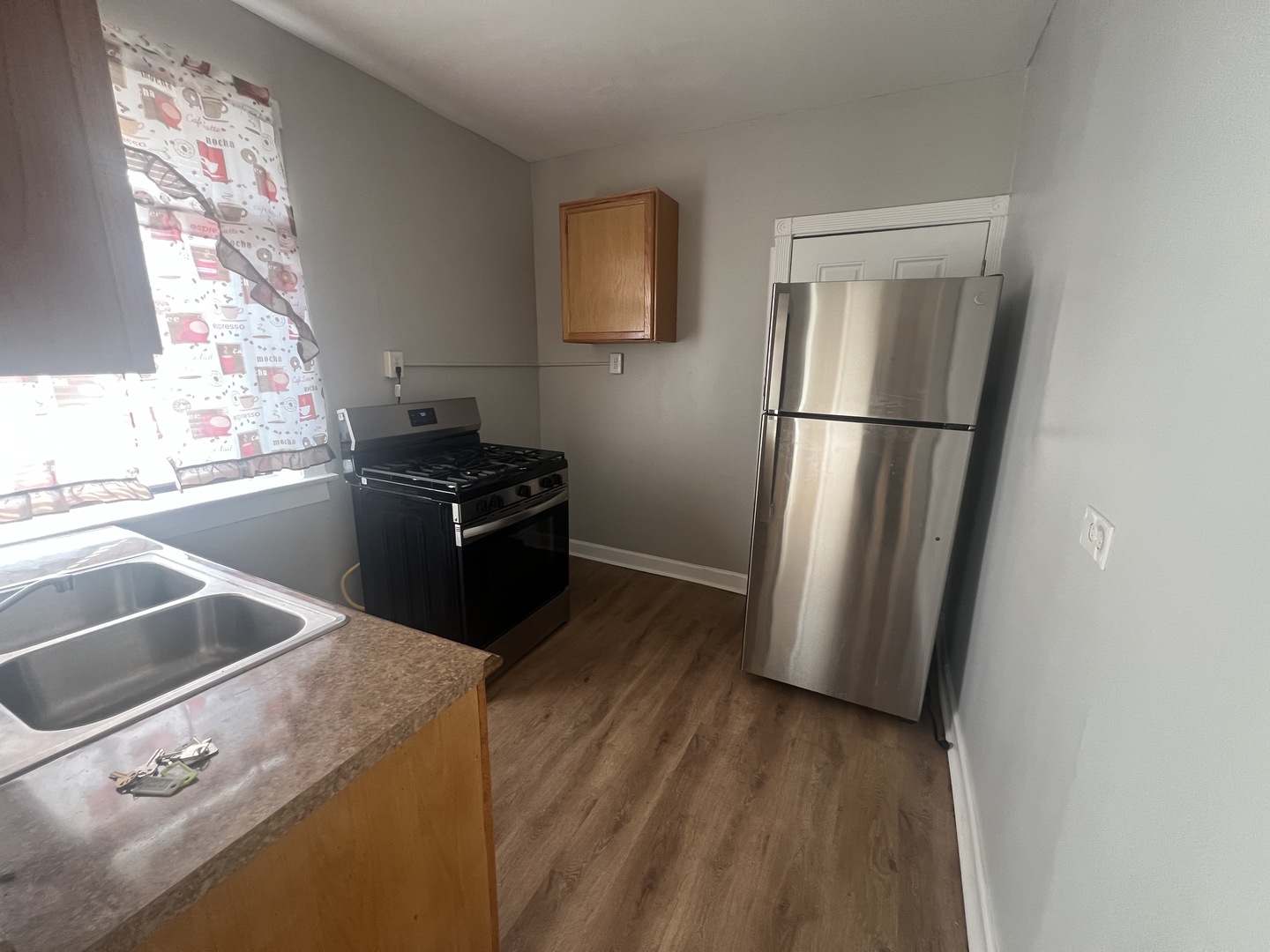 243 East 108th Street, Unit 2 Chicago, IL 60628 - Photo 7 of 8 a kitchen with a refrigerator and a sink