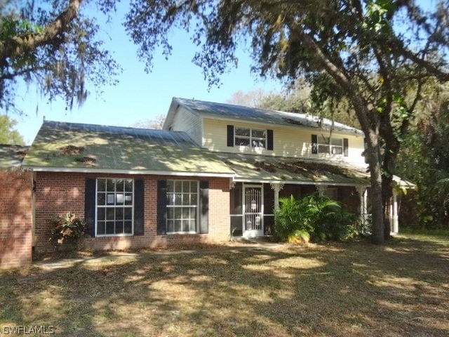 14071 Cemetery Road Fort Myers, FL 33905 - Photo 1 of 18 front view of a house with a trees