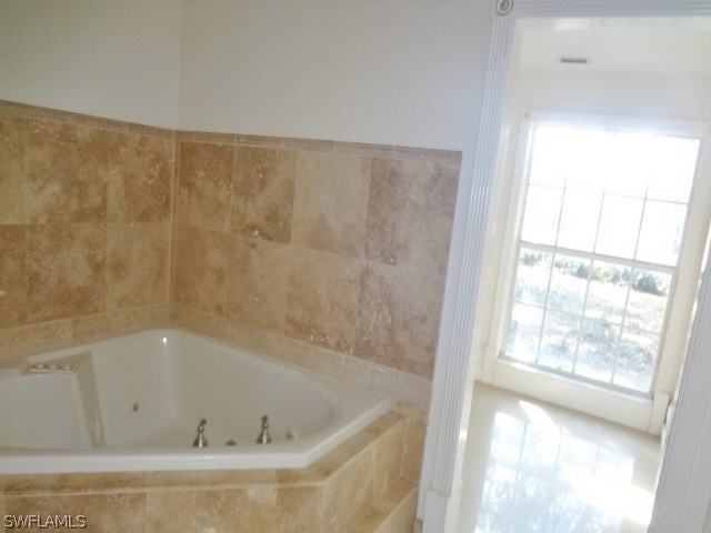 14071 Cemetery Road Fort Myers, FL 33905 - Photo 13 of 18 a bath tub sitting next to a window