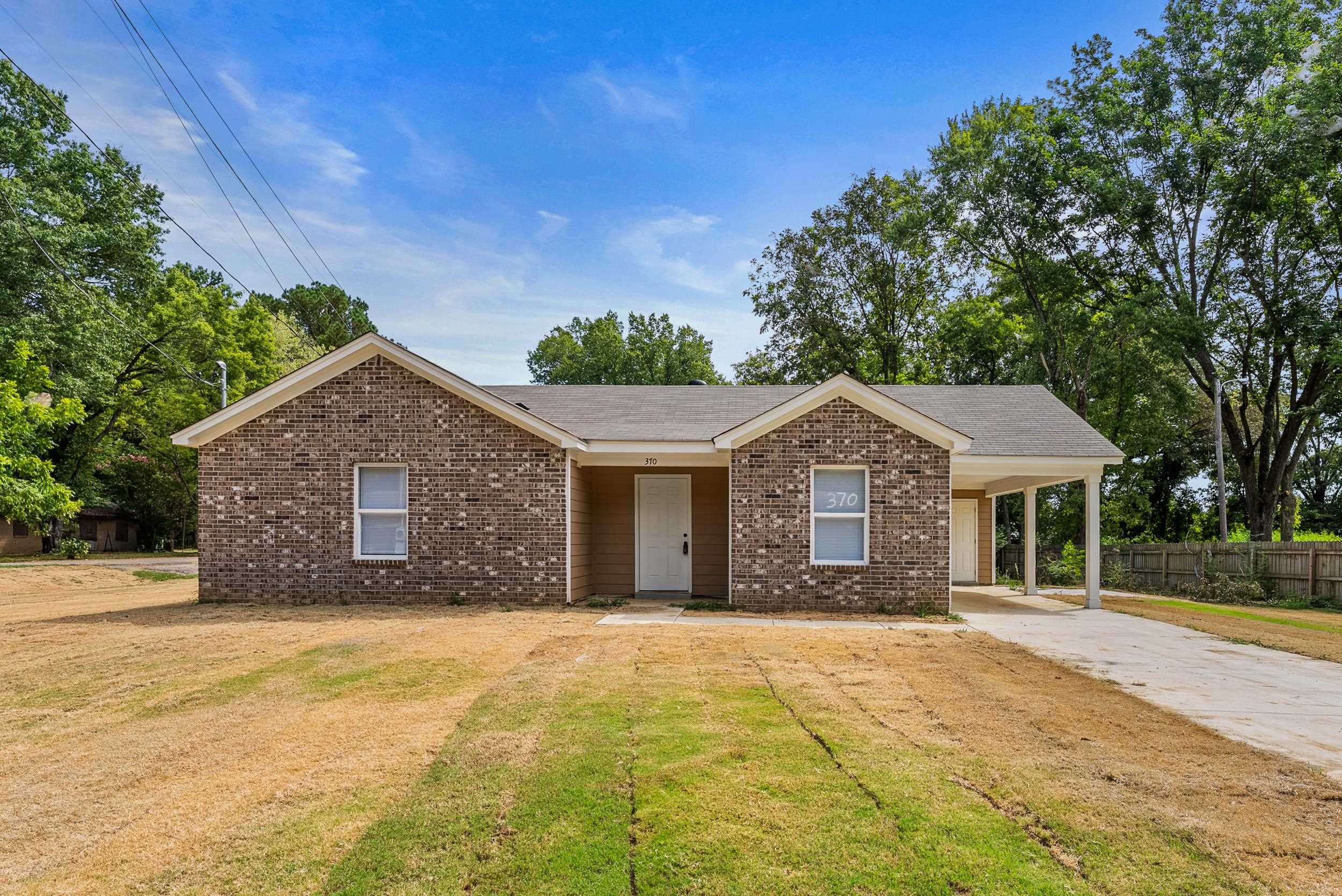 370 Watson Dr Extension Gallaway, TN 38002 - Photo 2 of 27 a front view of a house with a garden