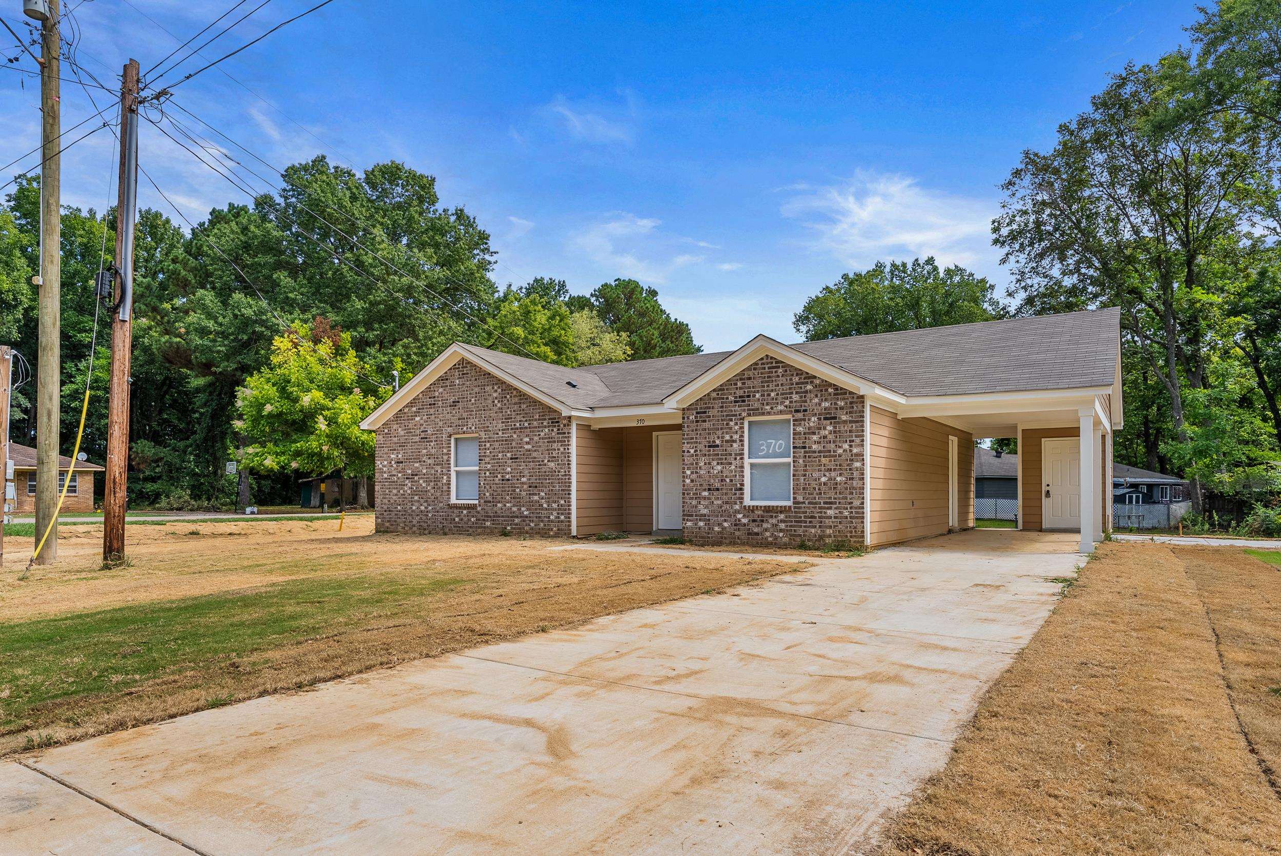 370 Watson Dr Extension Gallaway, TN 38002 - Photo 3 of 27 a front view of a house with a yard and trees
