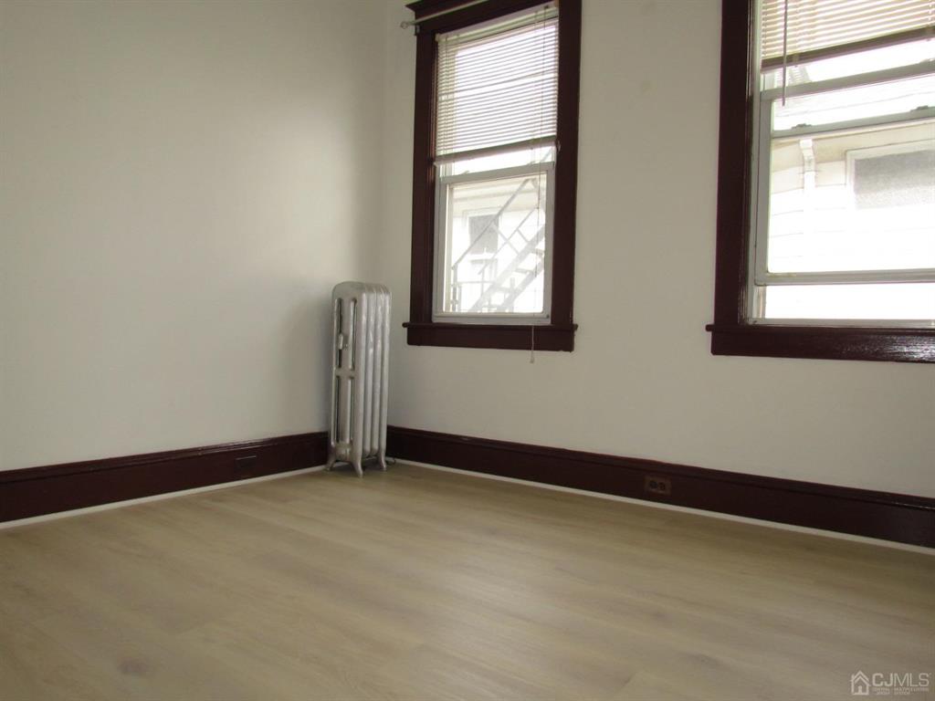 421 Magnolia Street, Unit 2 Highland Park, NJ 08904 - Photo 11 of 14 an empty room with windows