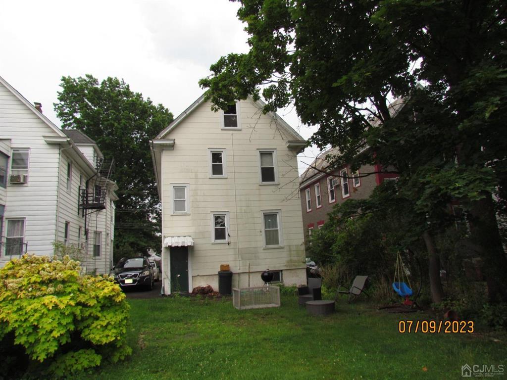 421 Magnolia Street, Unit 2 Highland Park, NJ 08904 - Photo 14 of 14 a white house that has tree in front of it