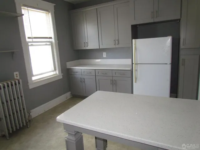 a kitchen with a refrigerator and window