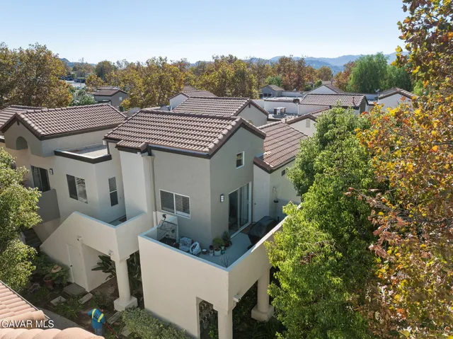 a aerial view of a house with a yard and balcony