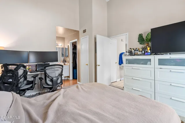 a bedroom with a bed and flat screen tv