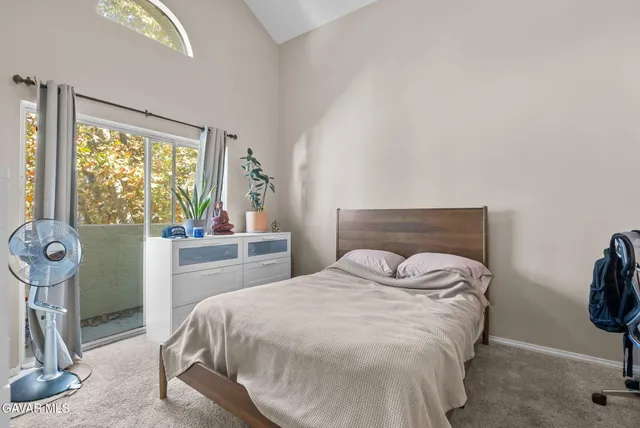 a bedroom with a bed and a mirror