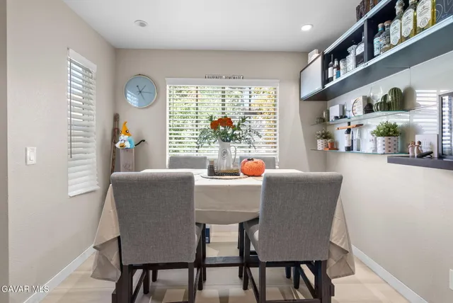 a dining room with furniture and a large window