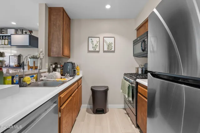 a kitchen with a sink appliances and cabinets
