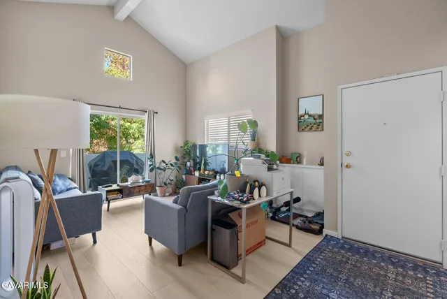 a living room with furniture a window and a table