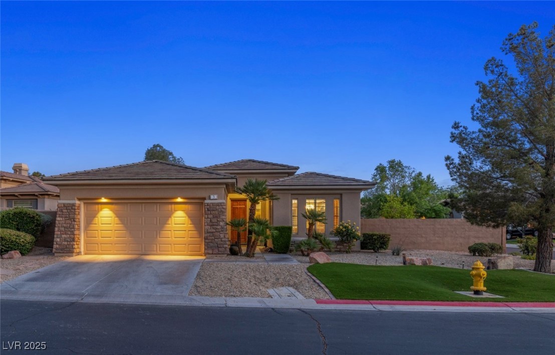 3 Chatmoss Road Henderson, NV 89052 - Photo 1 of 41 View of front of house with an attached garage, driveway, stucco siding, and a front yard