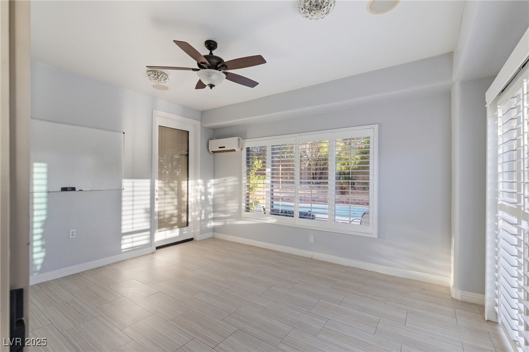 3 Chatmoss Road Henderson, NV 89052 - Photo 16 of 41 Empty room featuring baseboards, ceiling fan, and a wall unit AC