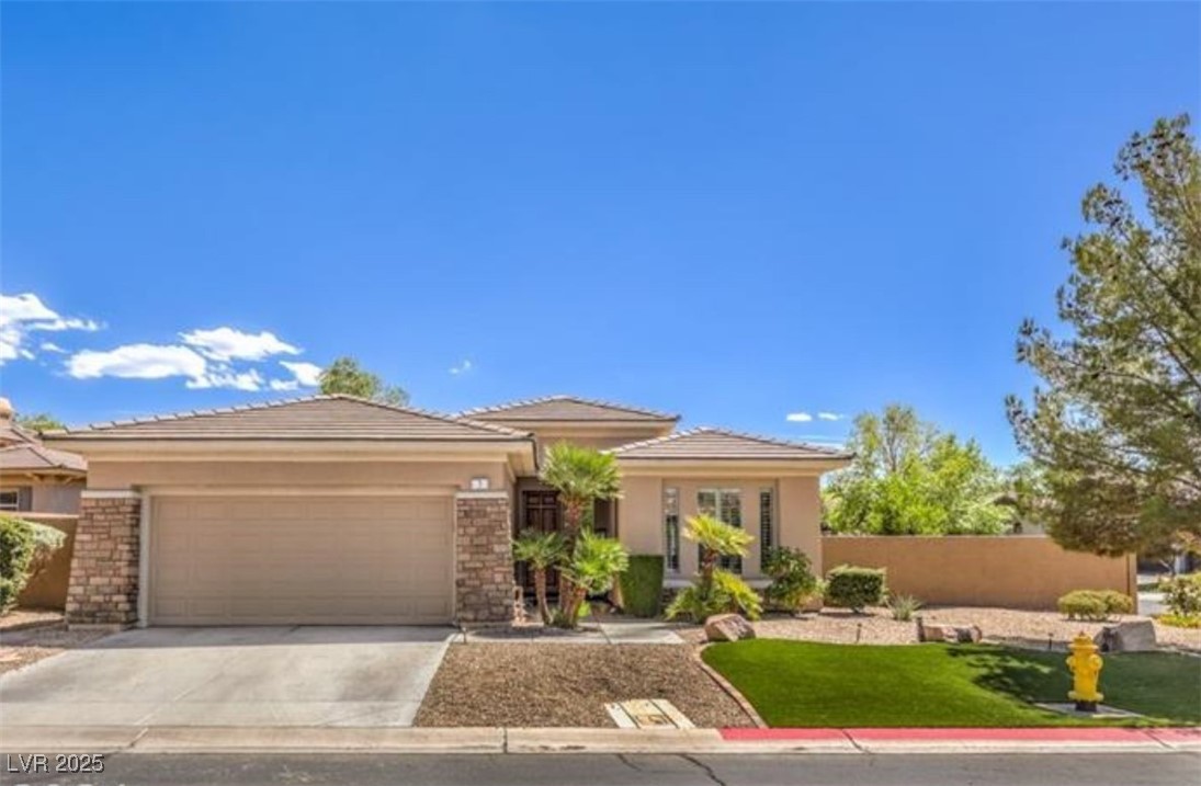 3 Chatmoss Road Henderson, NV 89052 - Photo 2 of 41 Prairie-style home featuring concrete driveway, a tiled roof, stucco siding, and a garage