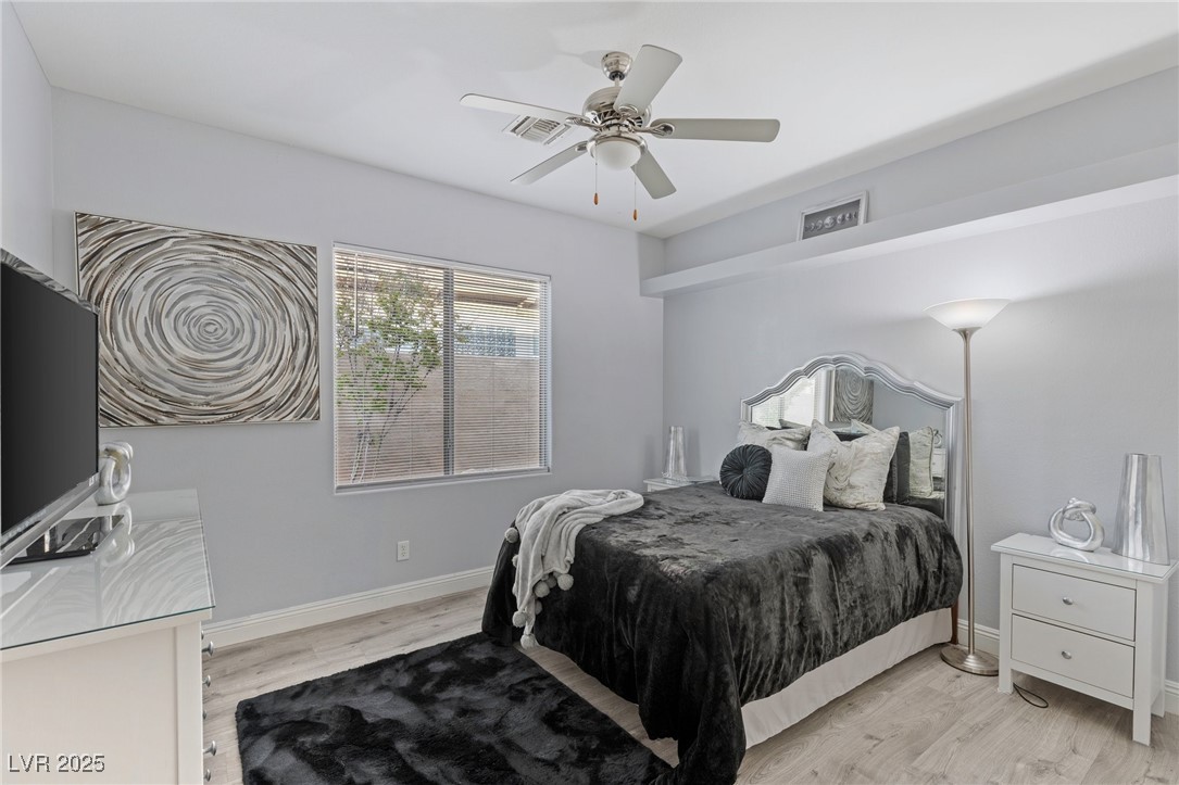3 Chatmoss Road Henderson, NV 89052 - Photo 26 of 41 Bedroom with baseboards, ceiling fan, light wood-type flooring, and visible vents